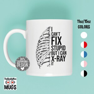 May include: White ceramic mug with a black and white illustration of a ribcage and the text "I can't fix stupid but I can x-ray it".