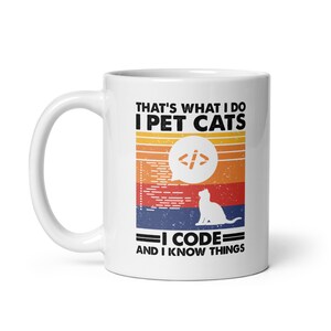 May include: White ceramic mug featuring the text "THAT'S WHAT I DO I PET CATS I CODE AND I KNOW THINGS." The design includes a cat silhouette, code symbols, and a retro sunset colour scheme.
