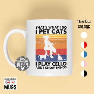 May include: White ceramic mug with a retro design featuring a woman playing a cello with two cats. The text reads "That's what I do I pet cats I play cello and I know things".
