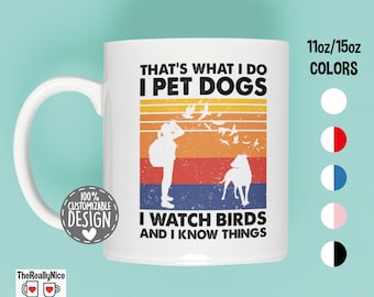 May include: White ceramic mug with a retro-style design featuring a person with a dog and birds. The text reads "That's what I do I pet dogs I watch birds and I know things".