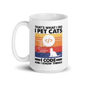 May include: White ceramic mug with a handle. The mug has the text "THAT'S WHAT I DO I PET CATS I CODE AND I KNOW THINGS." The design includes a retro sunset graphic, a cat silhouette, and a coding symbol.