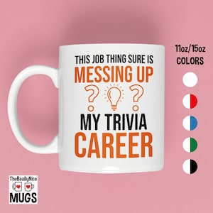 May include: White ceramic coffee mug with a black and orange design. The text on the mug reads "This job thing sure is messing up my trivia career". The mug is available in 11oz or 15oz sizes.