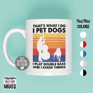 May include: White ceramic mug with a retro design featuring a silhouette of a person playing a double bass and a dog. The text reads "That's what I do I pet dogs I play double bass and I know things".