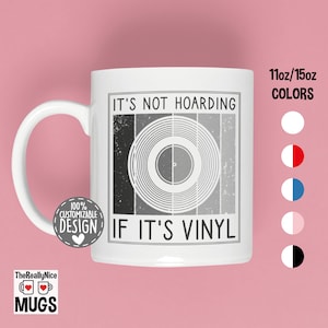 May include: White ceramic mug with the text "IT'S NOT HOARDING IF IT'S VINYL" and a graphic of a vinyl record. The mug has a white handle and the text "TheReallyNice MUGS" at the bottom. The mug is available in 11oz and 15oz sizes.