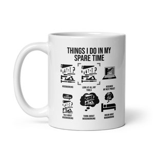May include: White ceramic mug with a black design that says "Things I do in my spare time" and lists woodworking activities like "Woodworking", "Look at all my tools", "Research my next project", "Talk about woodworking", "Think about woodworking", and "Dream about woodworking".