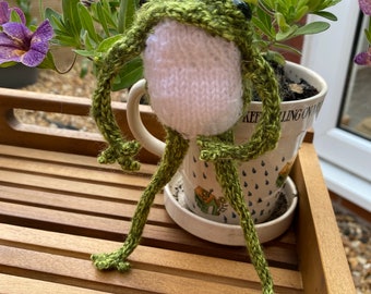 Speckled green hand knitted frog with with white tummy