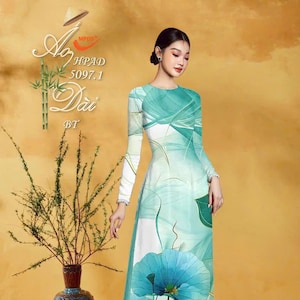 May include: A long-sleeved, floor-length dress with a teal and white abstract design and large blue lotus flower accents. The dress features a high neckline and is worn by a person. The image also includes text and a decorative vase.