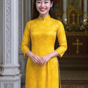 May include: A bright yellow traditional Vietnamese Ao Dai dress featuring a mandarin collar, three-quarter length sleeves, and a subtle tonal floral pattern throughout the fabric. The garment has side slits and a fitted silhouette.