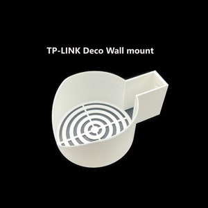 May include: White plastic wall mount for a TP-Link Deco smart home device. The mount has a circular opening with a grid pattern.