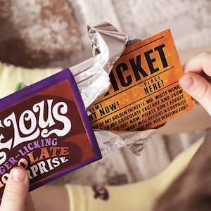 May include: A purple and brown chocolate bar with the text "Velous Finger-licking Chocolate Surprise" on the front. The bar is partially unwrapped, revealing a golden ticket with the text "Ticket Place Here!" and a message about a chocolate factory.