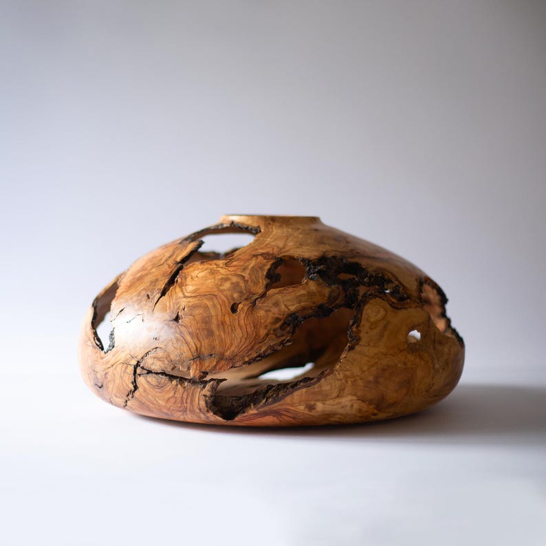 Handmade large wood vase, wabi-sabi aesthetic with irregular openings and sheen.
