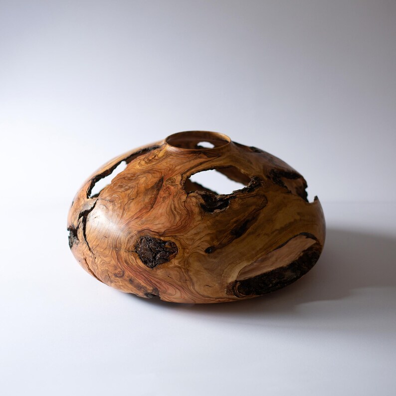 Handmade wood vase for entryway decor, hollow-form with flowing grain patterns.