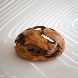 Modern wood vase centerpiece, hand turned with organic voids and smooth rim.