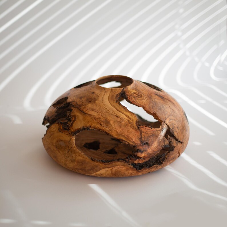 Modern wood vase centerpiece, hand turned with organic voids and smooth rim.