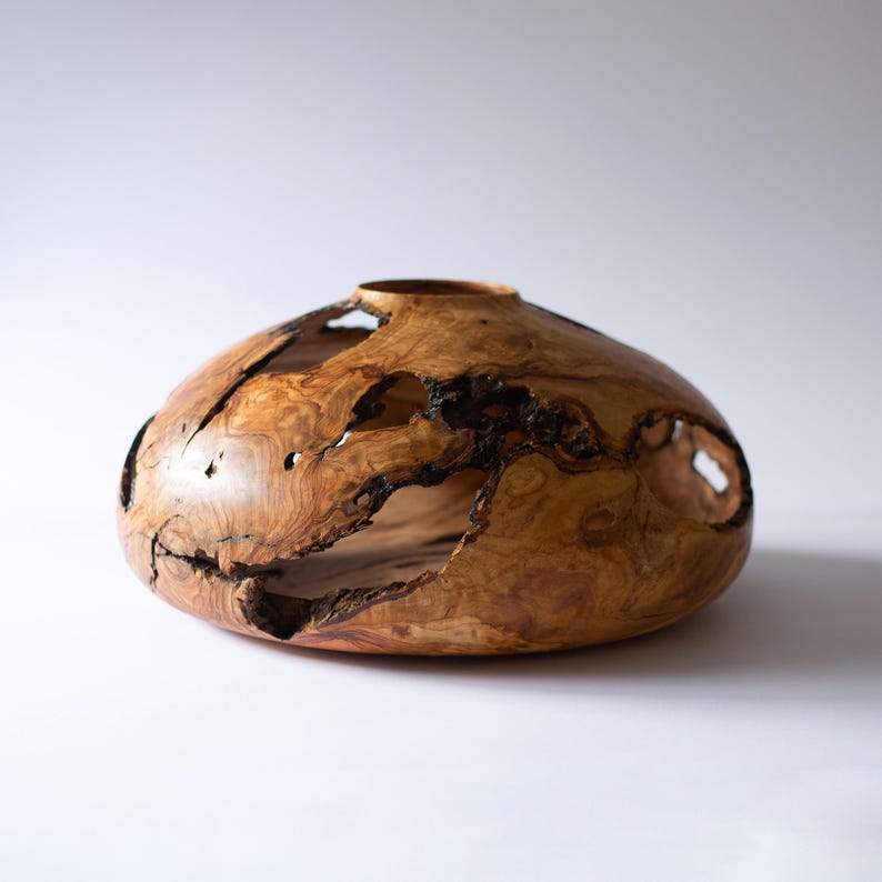 Olive wood centerpiece vase, close view of grain figure and live-edge details.