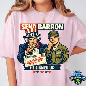 May include: Pink t-shirt featuring a graphic with Uncle Sam pointing and a soldier. Text includes "SEND BARRON", "DRAFT NOTICE", "VOLUNTEER", and "HE SIGNED UP". The design incorporates red, white, and blue colors.