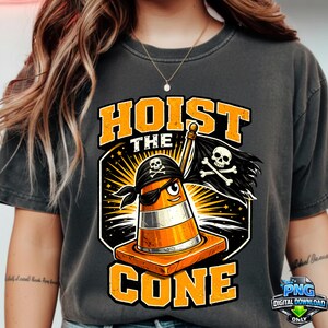 May include: Dark grey t-shirt featuring a cartoon traffic cone pirate with the text "HOIST THE CONE". The cone wears an eye patch and bandana, holding a skull and crossbones flag. The design is in orange and black.
