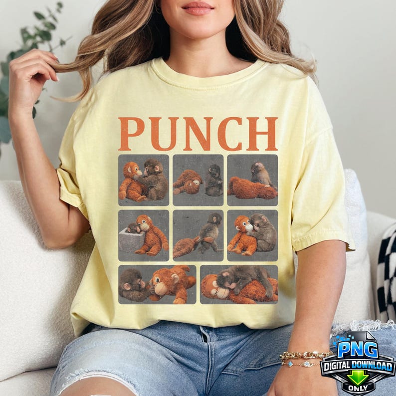 May include: A light yellow t-shirt with the word "PUNCH" in orange block letters. The shirt features a grid of nine squares, each with a different illustration of monkeys. The shirt is made of a soft material.