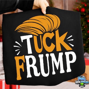 May include: Black tote bag with the text "TUCK FRUMP" in white and orange. The design includes an orange hairstyle graphic above the word "TUCK". The bag is held up by a person.