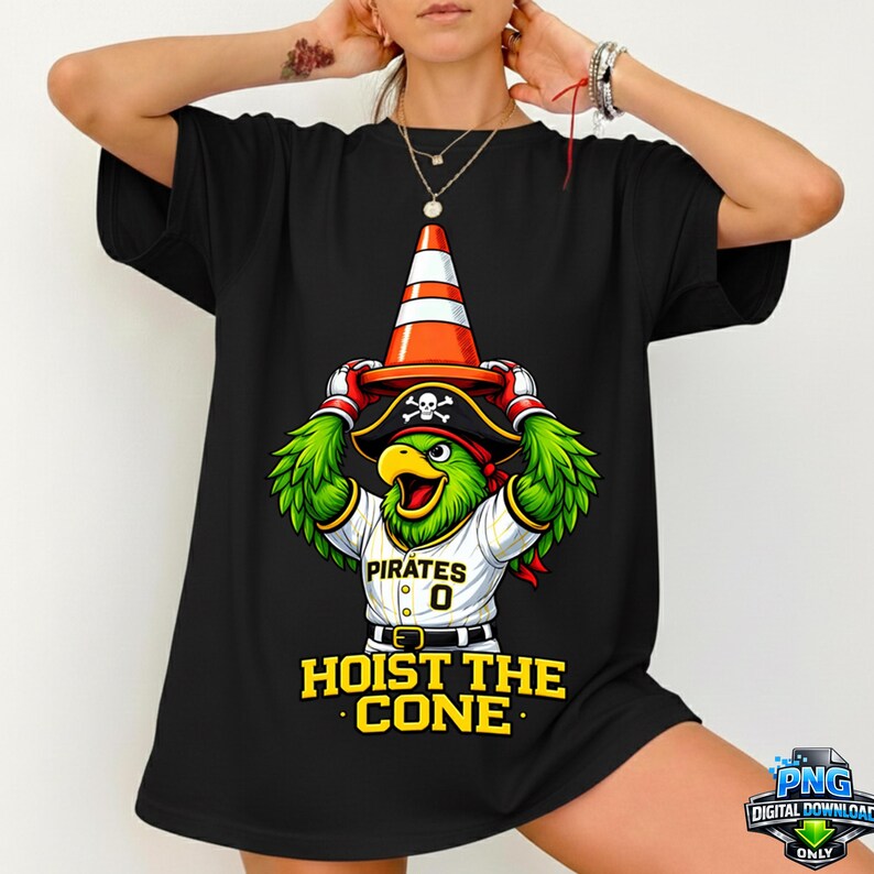 May include: Black t-shirt featuring a cartoon parrot wearing a pirate hat and a traffic cone. The parrot is wearing a baseball jersey with the word "Pirates" and the number "0". The text "HOIST THE CONE" is printed below the parrot.