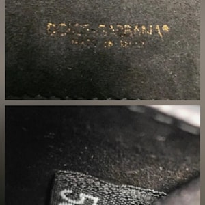 K&ouml;nnte beinhalten: Nahaufnahme eines schwarzen Stoffes mit goldfarbener Aufschrift "DOLCE & GABBANA" und "MADE IN ITALY". Darunter ein Etikett mit der wei&szlig;en Zahl "50".