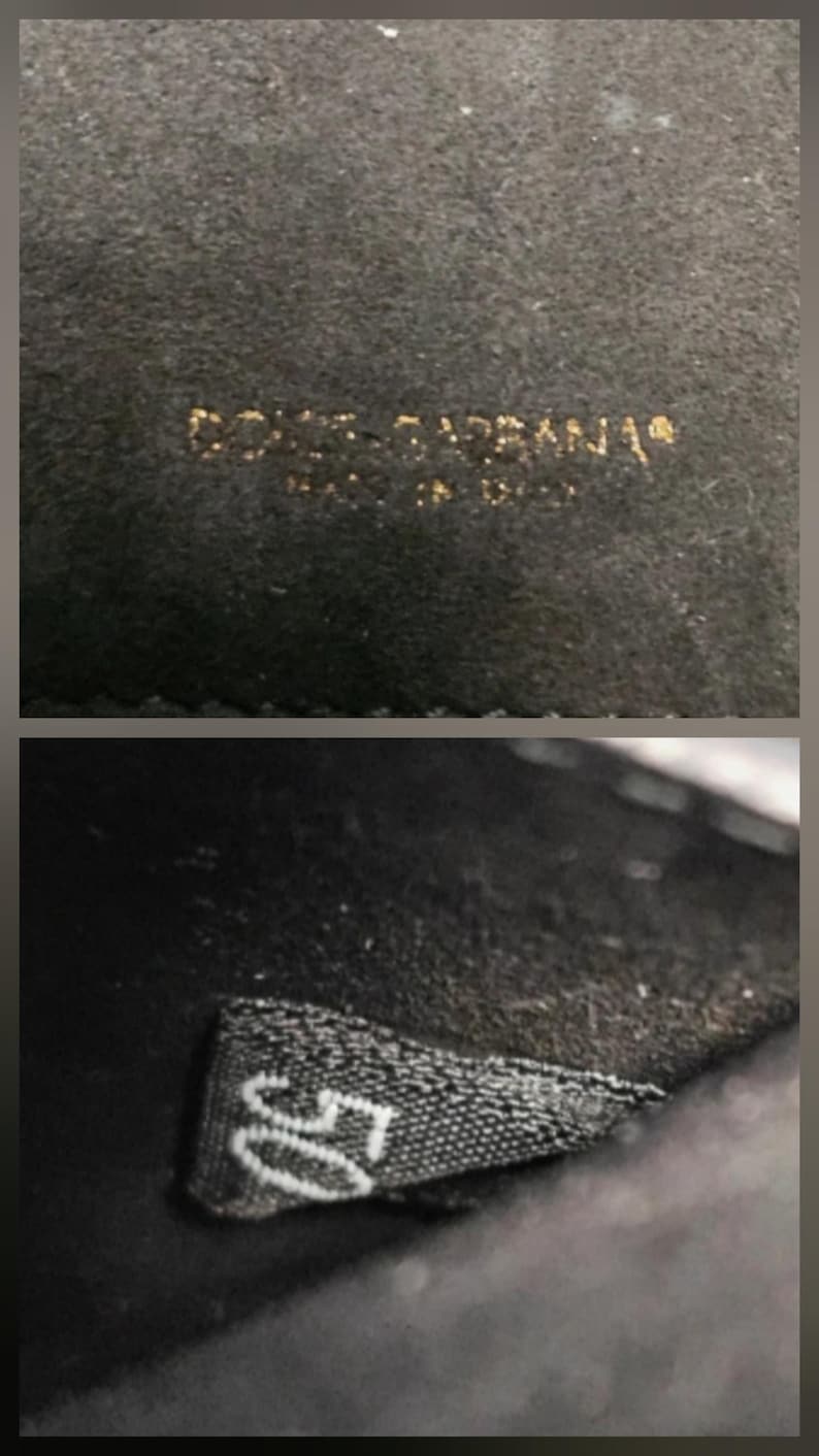 K&ouml;nnte beinhalten: Nahaufnahme eines schwarzen Stoffes mit goldfarbener Aufschrift "DOLCE & GABBANA" und "MADE IN ITALY". Darunter ein Etikett mit der wei&szlig;en Zahl "50".