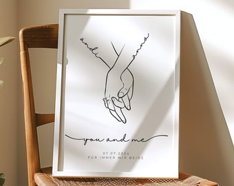 May include: A black and white line art print of two hands holding each other. The print has the text "you and me" and the date "07.07.2024" below the hands. The text "für immer wir beide" is below the date.