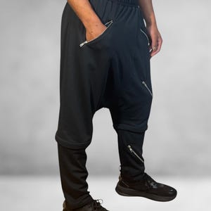 Low-crotch pants, avant-garde jogger pants, transformable pants, unisex trousers, alternative fashion, avant-garde clothing, black clothing