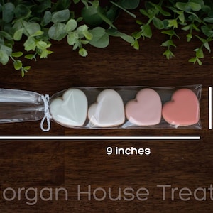 Single cookie sleeve resting on dark wood table with greenery at top of image. Image shows sleeve measures 9 inches long in total and 1.5 inches tall. Morgan House Treats watermark at bottom of image.