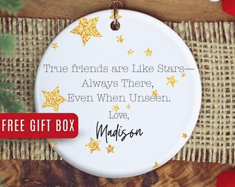 May include: White ceramic ornament with gold glitter stars and the text "True friends are Like Stars—Always There, Even When Unseen. Love, Madison." A red box with the text "FREE GIFT BOX" is in the lower left.