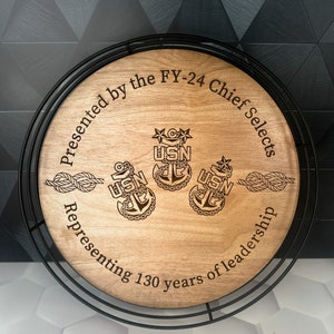 a wooden plaque with a coat of arms on it