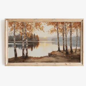 Peut inclure: Peinture de paysage encadrée représentant un lac paisible avec des bouleaux. Les arbres ont des feuilles jaunes et orangées, se reflétant dans l'eau calme. L'œuvre est dans un cadre en bois.