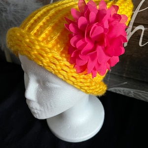 Bright and colorful yellow hat with removable flower.