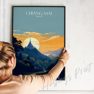 May include: A poster with a sunset scene of a mountain with a temple on top. The text "CHIANG MAI Thailand" is at the top of the poster.