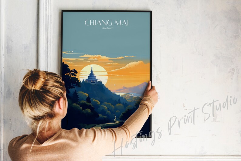 May include: A poster with a sunset scene of a mountain with a temple on top. The text "CHIANG MAI Thailand" is at the top of the poster.