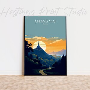 May include: A vintage travel poster with a black frame featuring a sunset scene of a temple on a hill in Chiang Mai, Thailand. The poster has the text "CHIANG MAI, Thailand" at the top.