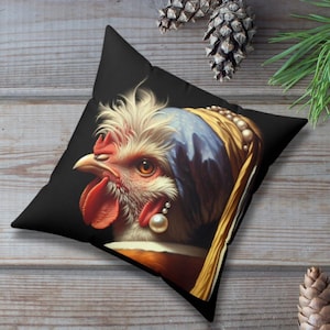 May include: A black throw pillow featuring a colourful image of a rooster wearing a blue and yellow headscarf and a pearl earring. The rooster's head is turned to the side and its beak is open.