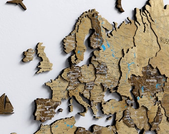 May include: A 3D wooden world map, showcasing Europe, Asia, and Africa. The map is crafted from light brown wood with dark brown borders, highlighting major cities and countries.