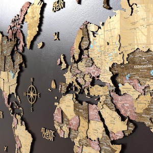 May include: A wooden world map with a dark background. The map is made of various shades of wood, including light brown and reddish-brown, with country borders and names. A compass and ocean names are also included. The map is a decorative piece.