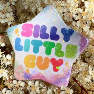 Silly Little Guy Holographic Button Pin - Star Shape 55mm Rainbow Meme Badge
