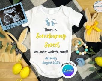 May include: A white onesie with blue bunny ears and yellow text that reads "There is Somebunny Sweet we can't wait to meet! Arriving August 2023".