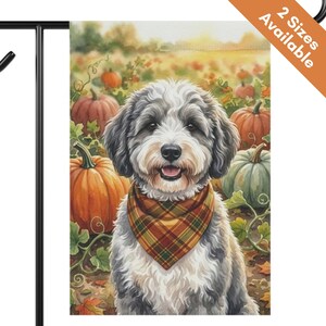May include: A rectangular garden flag featuring a watercolor illustration of a fluffy gray and white dog wearing a plaid bandana. The dog is positioned in a pumpkin patch with orange and green pumpkins. The text 2 Sizes Available is in the corner.