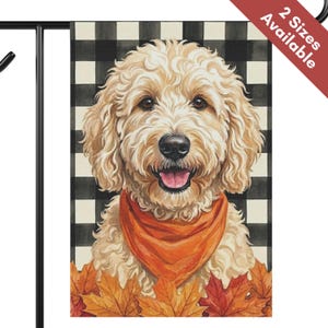 May include: A rectangular garden flag featuring a cream-colored Goldendoodle dog with curly fur, wearing an orange bandana. The dog is positioned in front of a black and white buffalo check pattern background with orange and red autumn leaves below.
