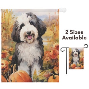 May include: A watercolor garden flag featuring a smiling black and white dog surrounded by pumpkins and fall foliage. The flag has the text "2 Sizes Available". The dog is the focal point of the design.
