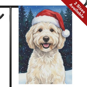 May include: A rectangular garden flag featuring a watercolor illustration of a cream-colored doodle dog wearing a red and white Santa hat. The dog is set against a dark blue background of pine trees with white snow falling in the winter scene.