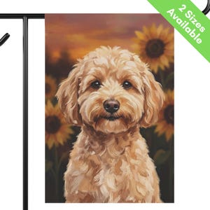 May include: A rectangular garden flag featuring a portrait of a fluffy, light brown dog with floppy ears and dark eyes. The background displays a field of yellow sunflowers under a warm, orange-toned sunset sky. The flag hangs on a black metal stand.