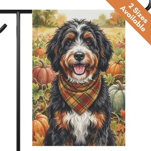 May include: A decorative garden flag featuring a Bernese Mountain Dog wearing a plaid bandana, set against a background of orange pumpkins and autumn foliage. The text 2 Sizes Available is printed in white on an orange banner in the corner.