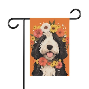 May include: A black and white dog with a flower crown on its head. The dog is wearing a flower garland around its neck. The background is orange.
