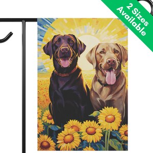 May include: A garden flag featuring a brown and a yellow Labrador Retriever dog sitting in a field of sunflowers. The dogs are smiling and have their tongues out. The background is a bright yellow and orange sunset.