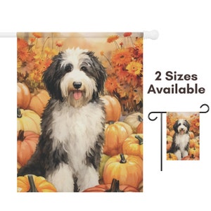 May include: A garden flag featuring a watercolor painting of a black and white dog sitting among pumpkins and fall foliage. The flag has a white pole and the text "2 Sizes Available" is visible.